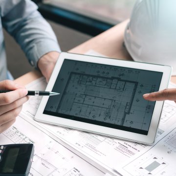 Looking at blueprints on digital display